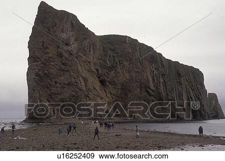 Gaspe Peninsula, Perce, Quebec, Canada, Perce Rock, Gulf of St. Lawrence, People walk out to Rocher Perce (Perce Rock) at low tide on the Gulf of St. Lawrence in Perce on Gaspe Peninsula in Quebec. View Large Photo Image Stock Photo - Gaspe Peninsula, Perce, Quebec, Canada, Perce Rock, Gulf of St. Lawrence, People walk out to Rocher Perce (Perce Rock) at low tide on the Gulf of St. Lawrence in Perce on Gaspe Peninsula in Quebec.. Fotosearch