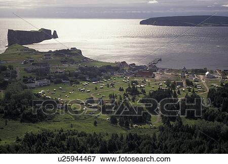 Gaspe Peninsula, Perce, Quebec, Canada, Rocher Perce, Gulf of St. Lawrence, Scenic aerial view of Perce Rock (Rocher Perce) and the town of Perce on the Gulf of St. Lawrence on Gaspe Peninsula in Quebec. View Large Photo Image Stock Photo - Gaspe Peninsula, Perce, Quebec, Canada, Rocher Perce, Gulf of St. Lawrence, Scenic aerial view of Perce Rock (Rocher Perce) and the town of Perce on the Gulf of St. Lawrence on Gaspe Peninsula in Quebec.. Fotosearch