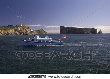 Gaspe Peninsula, Perce, Quebec, Canada, Rocher Perce, Gulf of St. Lawrence, Excursion boat heading back from a tour of Perce Rock (Rocher Perce) on the Gulf of St. Lawrence in Perce on Gaspe Peninsula in Quebec. View Large Photo Image Stock Photography - Gaspe Peninsula, Perce, Quebec, Canada, Rocher Perce, Gulf of St. Lawrence, Excursion boat heading back from a tour of Perce Rock (Rocher Perce) on the Gulf of St. Lawrence in Perce on Gaspe Peninsula in Quebec.. Fotosearch