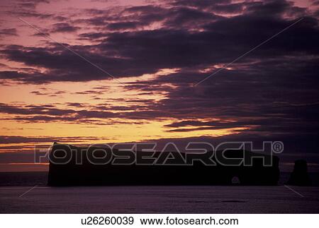 Gaspe Peninsula, sunrise, Perce, Quebec, Canada, Rocher Perce, Gulf of St. Lawrence, Scenic view of sunrise over Perce Rock (Rocher Perce) on the Gulf of St. Lawrence in Perce on Gaspe Peninsula in Quebec. View Large Photo Image Stock Photo - Gaspe Peninsula, sunrise, Perce, Quebec, Canada, Rocher Perce, Gulf of St. Lawrence, Scenic view of sunrise over Perce Rock (Rocher Perce) on the Gulf of St. Lawrence in Perce on Gaspe Peninsula in Quebec.. Fotosearch