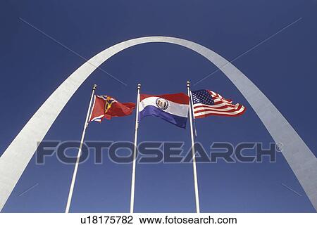 Stock Image -  Gateway Arch, St. Louis, MO, Missouri, Flags fly outside the Gateway Arch, Jefferson National Expansion Memorial, in Saint Louis.. Fotosearch