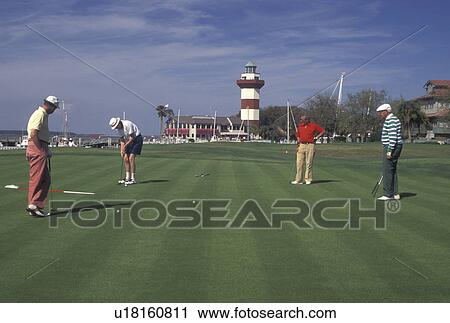 Stock Image -  golf, Hilton Head Island, SC, South Carolina, Golfer putting on the 18th Hole at the MCI Heritage Golf Classic in Harbour Town on Hilton Head Island.. Fotosearch
