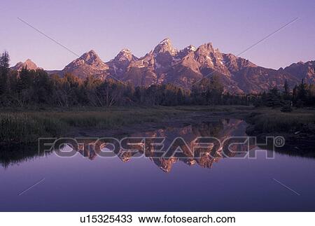 Grand Teton National Park, Snake River, Jackson Hole, WY, Wyoming, Scenic view of the Grand Teton Mountains reflecting in the calm waters of the Snake River at sunrise in Grand Teton Nat'l Park in Wyoming. View Large Photo Image Stock Image - Grand Teton National Park, Snake River, Jackson Hole, WY, Wyoming, Scenic view of the Grand Teton Mountains reflecting in the calm waters of the Snake River at sunrise in Grand Teton Nat'l Park in Wyoming.. Fotosearch