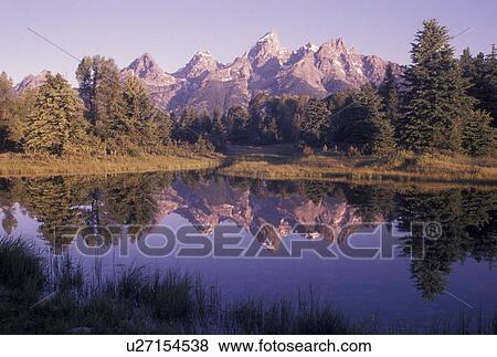Stock Photo -  Grand Teton National Park, Snake River, Jackson Hole, WY, Wyoming, Scenic view of the Grand Teton Mountains reflecting in the calm waters of the Snake River at sunrise in Grand Teton Nat'l Park in Wyoming.. Fotosearch