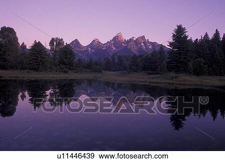 Grand Teton National Park, WY, sunrise, Snake River, Jackson Hole, Wyoming, Scenic view of the Grand Teton Mountains reflecting in the calm waters of the Snake River at sunrise in Grand Teton Nat'l Park in Wyoming. View Large Photo Image Stock Photo - Grand Teton National Park, WY, sunrise, Snake River, Jackson Hole, Wyoming, Scenic view of the Grand Teton Mountains reflecting in the calm waters of the Snake River at sunrise in Grand Teton Nat'l Park in Wyoming.. Fotosearch