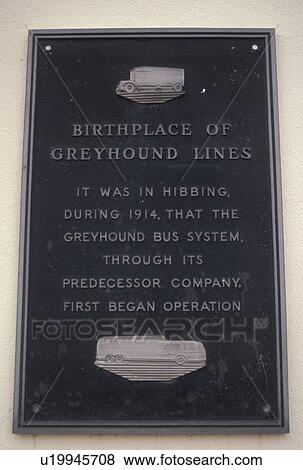 Stock Photo -  Greyhound Bus, Hibbing, MN, Minnesota, Birthplace of Greyhound Bus lines on a plaque on a wall in Hibbing.. Fotosearch