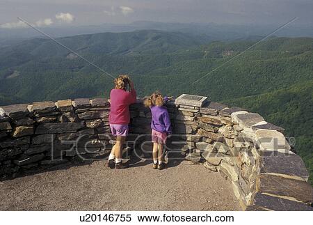 Stock Photography -  hiking, mountains NC, Blue Ridge Parkway, North Carolina, Mother and nine year old daughter at Devil's Courthouse Overlook along the Blue Ridge Parkway in North Carolina. Woman looking with binoculars.. Fotosearch