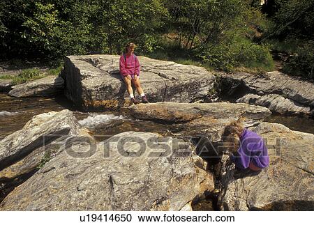 hiking, NC, Pisgah National Forest, North Carolina, Mother and nine year old daughter resting at Second Falls at Graveyard Fields in Pisgah National Forest in North Carolina. View Large Photo Image Stock Image - hiking, NC, Pisgah National Forest, North Carolina, Mother and nine year old daughter resting at Second Falls at Graveyard Fields in Pisgah National Forest in North Carolina.. Fotosearch