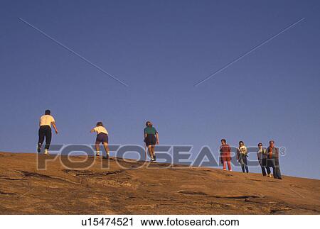Stock Image -  hiking, Stone Mountain, Atlanta, GA, Georgia, Georgia's Stone Mountain Park, People hiking up Stone Mountain, the largest single granite rock in the world, in Georgia's Stone Mountain Park.. Fotosearch