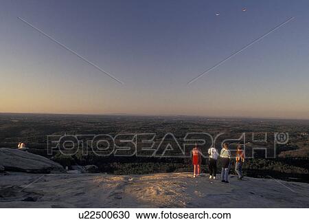 Stock Image -  hiking, Stone Mountain, Atlanta, GA, Georgia, Georgia's Stone Mountain Park, People taking in the scenic views on the summit of Stone Mountain, the largest single granite rock in the world, in Georgia's Stone Mountain Park.. Fotosearch