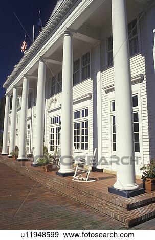 Stock Photo -  historic inn, Aiken, SC, South Carolina, Columns and rocking chairs on the front porch of The Wilcox Inn in Aiken.. Fotosearch