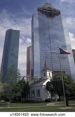 Stock Image -  Houston, TX, skyline, Texas, Church at Sam Houston Historical Park with modern downtown skyline of Houston.. Fotosearch