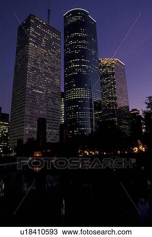 Stock Image -  Houston, TX, skyline, Texas, High-rise buildings in downtown Houston from Tranquility Park at sunset.. Fotosearch