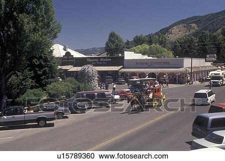 Stock Image -  Jackson, WY, Wyoming, A stage coach carries tourists through downtown Jackson.. Fotosearch