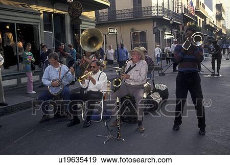 Stock Photo -  jazz, French Quarter, street musicians, New Orleans, LA, Louisiana, Street musicians entertain a crowd of people along the street in the French Quarter in New Orleans. . Fotosearch