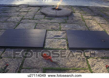 Stock Photo -  JFK, John F. Kennedy, Arlington National Cemetery, VA, Arlington, Virginia, Grave sites of John F. Kennedy and Jacqueline Kennedy next to the eternal flame at the Arlington Nat'l Cemetery.. Fotosearch