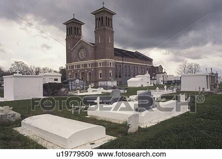 Stock Photo -  LA, Louisiana, Edgard, Graves above ground at St. John the Baptist Cemetery & Catholic Church in Edgard.. Fotosearch