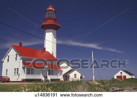 Stock Image -  lighthouse, Gaspe Peninsula, Quebec, Metis-sur-Mer, Canada, Gulf of St. Lawrence, Pointe-de-Mitis Lighthouse with red roof in Metis-Sur-Mer along the St. Lawrence River on the Gaspe Peninsula in Quebec.. Fotosearch