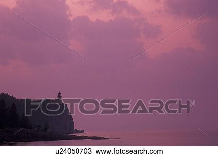 Stock Image -  lighthouse, Lake Superior, North Shore Drive, Two Harbors, MN, Minnesota, Scenic view of Split Rock Lighthouse is situated on a high cliff on the north shore of Lake Superior at sunrise at Split Rock Lighthouse State Park in Two Harbors.. Fotosearch