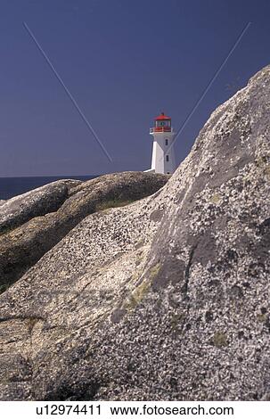 Stock Image -  lighthouse, Peggy's Cove, Nova Scotia, NS, Canada, Atlantic Ocean, The old lighthouse stands on top of a massive granite rock in Peggy's Cove in Nova Scotia. . Fotosearch