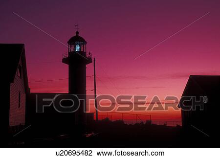 Stock Image -  lighthouse, sunrise, Gaspe Peninsula, Quebec, Sainte-Madelaine-de-la-Riviere-Madelaine, Canada, Gulf of St. Lawrence, Cap Madelaine lighthouse at sunrise on Cap Madelaine on the Gaspe Peninsula on the St. Lawrence River in Quebec.. Fotosearch