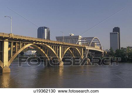 Stock Image -  Little Rock, bridge, skyline, AR, Arkansas, Bridge crosses the Arkansas River and a view of the downtown skyline of Little Rock.. Fotosearch