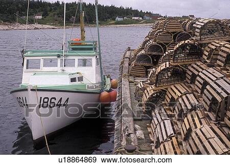 Stock Photo -  lobster traps, fishing boat, Cape Breton, Cabot Trail, Nova Scotia, NS, Canada, Atlantic Ocean, Scenic view of New Haven Harbor on Cape Breton Island on in Nova Scotia. . Fotosearch