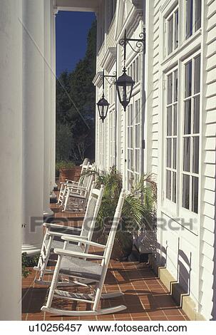 Stock Photo -  lodging, Aiken, SC, South Carolina, Columns and rocking chairs on the front porch of The Wilcox Inn in Aiken.. Fotosearch