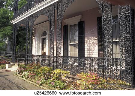 Stock Image -  mansion, New Orleans, LA, Louisiana, Garden District, Ornate mansion with cast iron railings in the Garden District in New Orleans. . Fotosearch