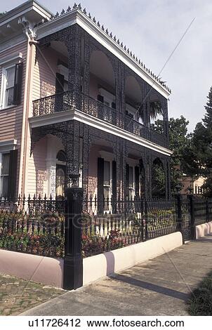 Stock Image -  mansion, New Orleans, Louisiana, Garden District, LA, Ornate mansion with cast iron railings in the Garden District in New Orleans. . Fotosearch