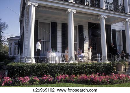 mansion, New Orleans, Louisiana, Garden District, LA, People sitting on the front porch of a historic mansion in the Garden District in New Orleans. View Large Photo Image Stock Image - mansion, New Orleans, Louisiana, Garden District, LA, People sitting on the front porch of a historic mansion in the Garden District in New Orleans. . Fotosearch