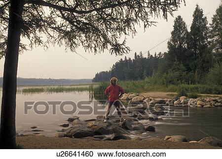 Mississippi River, Itasca State Park, MN, Minnesota, Park Rapids, Lake Itasca, A woman walks across the narrow headwaters of the Mississippi River on large rocks in Itasca State Park. View Large Photo Image Stock Image - Mississippi River, Itasca State Park, MN, Minnesota, Park Rapids, Lake Itasca, A woman walks across the narrow headwaters of the Mississippi River on large rocks in Itasca State Park.. Fotosearch