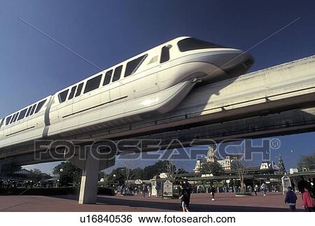 Stock Photograph -  monorail, Disney World, FL, Orlando, Lake Buena Vista, Florida, Monorail glides across a bridge over the entrance to Walt Disney World in Lake Buena Vista.. Fotosearch