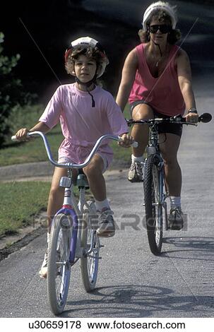 mother, daughter, biking, Stone Mountain, GA, Atlanta, Georgia, Mother and eight year old daughter biking with helmets on at Georgia's Stone Mountain Park in Stone Mountain. View Large Photo Image Stock Photo - mother, daughter, biking, Stone Mountain, GA, Atlanta, Georgia, Mother and eight year old daughter biking with helmets on at Georgia's Stone Mountain Park in Stone Mountain. . Fotosearch