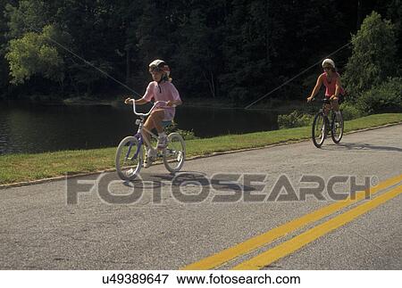 mother, daughter, biking, Stone Mountain, GA, Atlanta, Georgia, Mother and eight year old daughter biking with helmets on at Georgia's Stone Mountain Park in Stone Mountain. View Large Photo Image Stock Photo - mother, daughter, biking, Stone Mountain, GA, Atlanta, Georgia, Mother and eight year old daughter biking with helmets on at Georgia's Stone Mountain Park in Stone Mountain. . Fotosearch