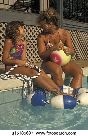 mother, daughter, swimming pool, GA, Atlanta, Georgia, Mother and eight year old daughter talk together while sitting on the side of a pool in Atlanta.  View Large Photo Image Stock Photo -  mother, daughter, swimming pool, GA, Atlanta, Georgia, Mother and eight year old daughter talk together while sitting on the side of a pool in Atlanta. . Fotosearch
