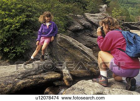NC, Pisgah National Forest, North Carolina, Mother takes a picture of her nine year old daughter as they take a break at Second Falls at Graveyard Fields in Pisgah National Forest in North Carolina. View Large Photo Image Picture - NC, Pisgah National Forest, North Carolina, Mother takes a picture of her nine year old daughter as they take a break at Second Falls at Graveyard Fields in Pisgah National Forest in North Carolina.. Fotosearch