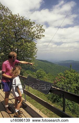 NC, Pisgah National Forest, North Carolina, Father points showing his nine year old daughter the scenic view of the mountains at Pisgah Lodge overlook off of the Blue Ridge Parkway in North Carolina. View Large Photo Image Stock Photo - NC, Pisgah National Forest, North Carolina, Father points showing his nine year old daughter the scenic view of the mountains at Pisgah Lodge overlook off of the Blue Ridge Parkway in North Carolina.. Fotosearch