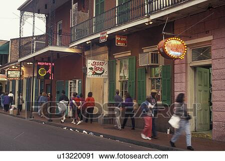 Stock Image -  New Orleans, French Quarter, Louisiana, LA, Illuminated store fronts along the street in the French Quarter in New Orleans.. Fotosearch