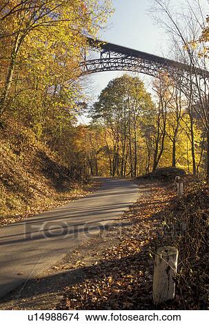 New River Gorge, WV, fall foliage, West Virginia, New River Gorge Bridge, the world's longest steel-arch span bridge, crosses the New River Recreation Path at the New River Gorge National River in Fayetteville in autumn. View Large Photo Image Picture - New River Gorge, WV, fall foliage, West Virginia, New River Gorge Bridge, the world's longest steel-arch span bridge, crosses the New River Recreation Path at the New River Gorge National River in Fayetteville in autumn.. Fotosearch