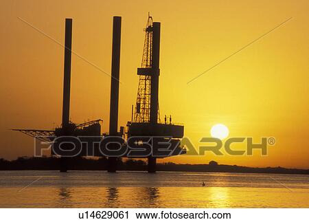 oil rig, Port Arthur, TX, Texas, Gulf of Mexico, Silhouette of an offshore oil rig at sunrise of the Gulf of Mexico in Port Arthur. View Large Photo Image Stock Image - oil rig, Port Arthur, TX, Texas, Gulf of Mexico, Silhouette of an offshore oil rig at sunrise of the Gulf of Mexico in Port Arthur.. Fotosearch