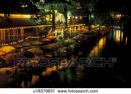 Stock Image -  outdoor cafT, The Riverwalk, San Antonio, TX, Texas, Outdoor cafes and restaurants along Paseo Del Rio, The Riverwalk, in downtown San Antonio in the evening. . Fotosearch