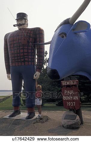 Paul Bunyan, Bemidji, MN, Minnesota, Woman holds the hand of the giant statue of Paul Bunyan with Babe the Blue Ox in Bemidji. View Large Photo Image Stock Photo - Paul Bunyan, Bemidji, MN, Minnesota, Woman holds the hand of the giant statue of Paul Bunyan with Babe the Blue Ox in Bemidji.. Fotosearch
