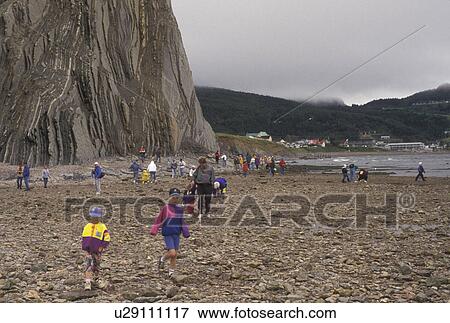Perce, Quebec, Gaspe Peninsula, Canada, Rocher Perce, Gulf of St. Lawrence, People walking to and from Rocher Perce (Perce Rock) at low tide on the Gulf of St. Lawrence in Perce on Gaspe Peninsula in Quebec. View Large Photo Image Stock Photo - Perce, Quebec, Gaspe Peninsula, Canada, Rocher Perce, Gulf of St. Lawrence, People walking to and from Rocher Perce (Perce Rock) at low tide on the Gulf of St. Lawrence in Perce on Gaspe Peninsula in Quebec.. Fotosearch