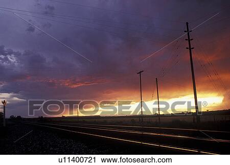 railroad, sunset, train tracks, WY, Lovell, Wyoming, Train tracks and powerlines at sunset in Wyoming. View Large Photo Image Stock Image - railroad, sunset, train tracks, WY, Lovell, Wyoming, Train tracks and powerlines at sunset in Wyoming.. Fotosearch
