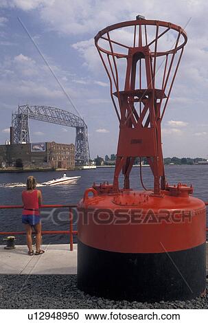 red warning buoy, Duluth, MN, Minnesota, Lake Superior, Woman looking out at Duluth Harbor and Aerial Lift Bridge on Lake Superior in Duluth. View Large Photo Image Stock Image - red warning buoy, Duluth, MN, Minnesota, Lake Superior, Woman looking out at Duluth Harbor and Aerial Lift Bridge on Lake Superior in Duluth.. Fotosearch