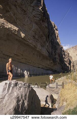 Rio Grande River, rafting, hiking, river, Texas, TX, Two men standing on rocks along the Rio Grande River in Santa Helena Canyon in Big Bend National Park on the Mexican and U. S. border. View Large Photo Image Stock Photo - Rio Grande River, rafting, hiking, river, Texas, TX, Two men standing on rocks along the Rio Grande River in Santa Helena Canyon in Big Bend National Park on the Mexican and U. S. border.. Fotosearch