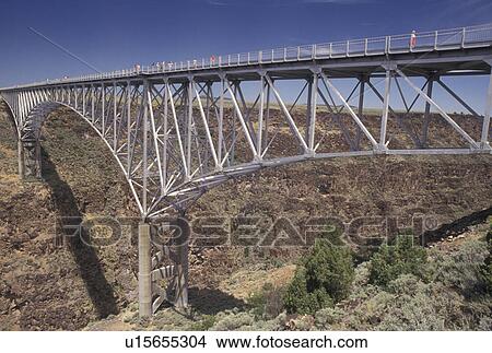 Rio Grande, steel bridge, NM, New Mexico, Rio Grande River, The three-span continuous-truss bridge crosses the Rio Grande Gorge near Taos. One of the highest bridges in the United States. View Large Photo Image Picture - Rio Grande, steel bridge, NM, New Mexico, Rio Grande River, The three-span continuous-truss bridge crosses the Rio Grande Gorge near Taos. One of the highest bridges in the United States.. Fotosearch