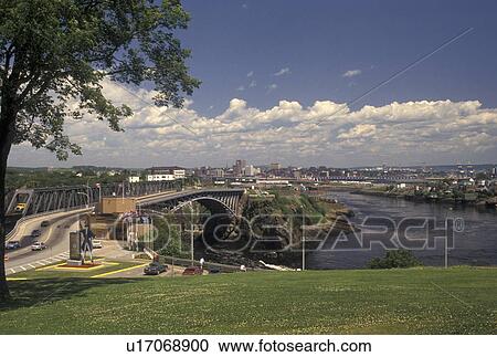 Stock Image -  river, falls, New Brunswick, Saint John, NB, Canada, Scenic view of The Reversing Falls at the narrow rocky gorge where the Saint John River's rapids meet the Bay of Fundy in St. John in New Brunswick.. Fotosearch