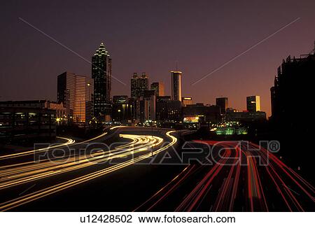 road, Atlanta, GA, skyline, Georgia, Traffic lights streak on I-75/I-85 at sunset and view of the skyline of downtown Atlanta. View Large Photo Image Stock Image - road, Atlanta, GA, skyline, Georgia, Traffic lights streak on I-75/I-85 at sunset and view of the skyline of downtown Atlanta.. Fotosearch